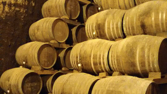 Dust-covered barrels in a wine cellar